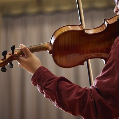 Close up shot of student playing violin